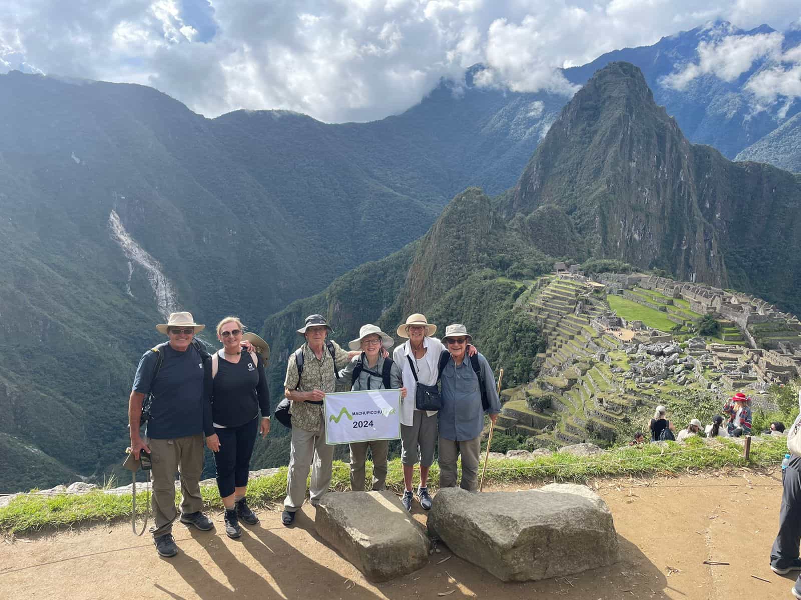 Tourists at Machu Picchu with 2024 sign.