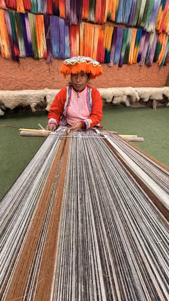 Andean weaver working on a traditional loom in Cusco, Peru